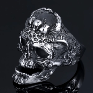 Punk style hollow skull stainless steel ring with vintage silver finish on black background