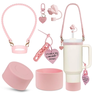 Pink silicone accessory set for tumbler featuring heart straw cover and handle strap