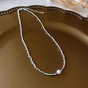 Detail of silver irregular bead necklace with a white pearl and 925 lobster clasp