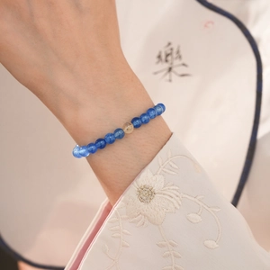Detail of a New Chinese style beaded bracelet with blue stone and yellow crystal bead