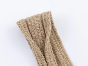 Macro detail of khaki ribbed knit texture with a stylish cross twist knot design