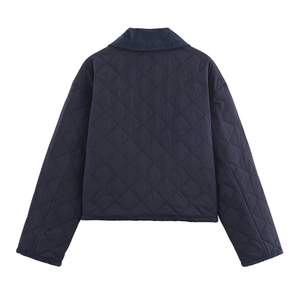 Detail view of the back of a navy blue quilted jacket with a classic diamond pattern