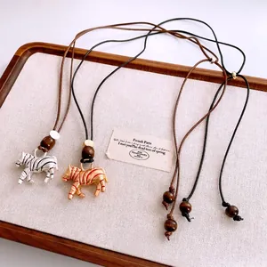 Vintage zebra pendant necklace with wood beads and adjustable leather cord straps