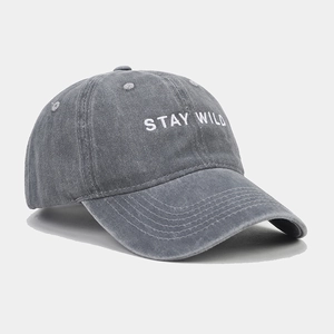 Close-up of the vintage washed grey cotton baseball cap with white STAY WILD embroidery