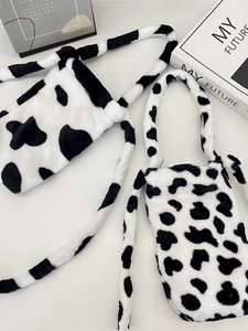 Cute cow print plush water bottle bag with crossbody strap and handle in soft faux fur