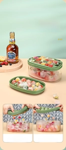 Detailed view of green ice cube tray set including square and round spherical molds