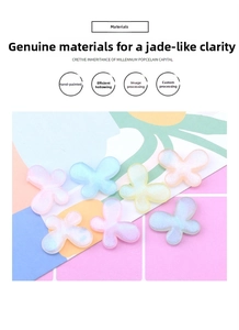 Close-up of seven glittery resin butterfly beads in pastel macaron gradient colors