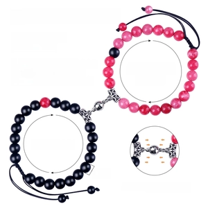 Detail of 8mm natural stone couple bracelets showing magnetic heart clasp connection