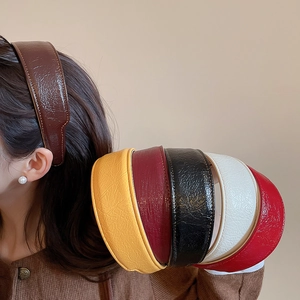 Detail of pleated PU leather headband showing textured finish and fine side stitching