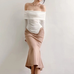 Close-up of white off-shoulder knit top with irregular hem and ribbed texture detail