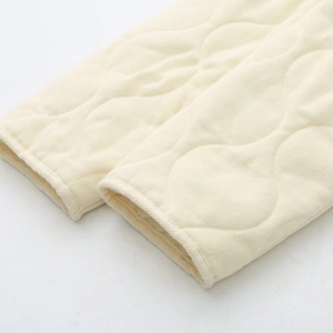 Detail of diamond quilted texture and premium stitching on beige jacket cuff