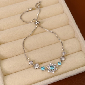 Close-up of snowflake bracelet with blue zircon inlay and adjustable slide clasp detail