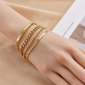 Chic multilayered gold-tone titanium steel chain bracelet set worn by model