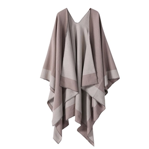 Women's reversible knit poncho cape with pink and grey stripes on a white background