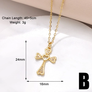 Dettaglio collana croce dorata 24x16mm con cuore traforato e pietre scintillanti