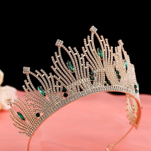 Macro detail of luxury Baroque crown with green crystals and sparkling rhinestones