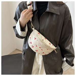 White cherry print fanny pack with golden zipper and patterned wide fabric strap