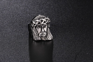 Macro detail of retro Jesus Christ embossed relief on a vintage stainless steel ring