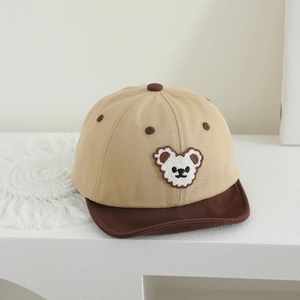 Detailed close-up of khaki baby baseball cap with bear embroidery and soft brown brim