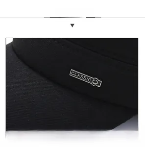 Detail view of winter wool cap with classic silver metal badge and twill texture