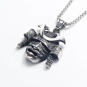 Macro detail of vintage silver samurai warrior helmet and mask pendant on box chain