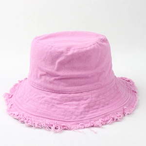 Close-up of pink canvas bucket hat with frayed raw edges and fringe detail design