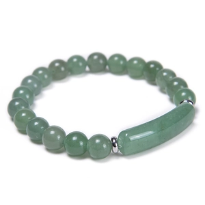 Detail of green jade beads bracelet featuring a central long tube charm and metal spacers