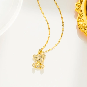 Macro shot of gold-plated bear necklace pendant with glittering micro-set stones