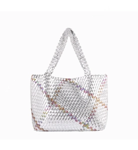 Detailed shot of silver woven tote bag with iridescent stripes and metallic finish