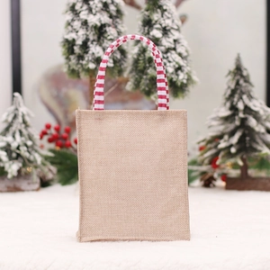 Christmas burlap gift bag with red striped handles and festive gnome forest design