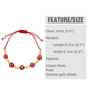 Detailed view of red woven bracelet with evil eye pendants and gold bead accents