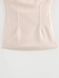 Detail shot of beige linen fabric texture with waist pleats and side slit craftsmanship