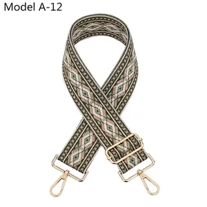 Close-up of diamond pattern jacquard strap with gold-tone metal lobster clasps and buckle