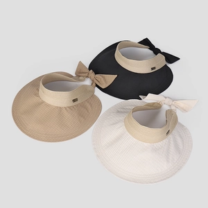Three wide-brim sun hats in black, khaki, and beige with bows and woven texture detail