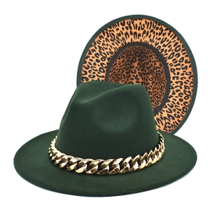 Detail of dark green wool fedora featuring gold chain strap and leopard print brim lining