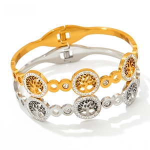 Detail of tree of life cutout bangle with pavé rhinestones in gold and silver finish
