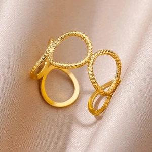 Minimalist 18k gold plated hollow flower interlocking ring on pink silk background