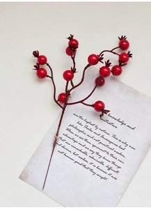 Detailed view of glossy red berry stems on a vintage decorative card for Christmas decor