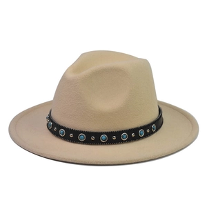 Detail of beige wool fedora featuring turquoise gemstone chain and gold metal studs