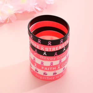 Pink ribbon silicone bracelet set with hope and strength motivational text on pink backdrop