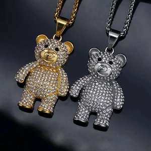 Macro shot of hip hop bear pendants in gold and silver finish with pave rhinestones