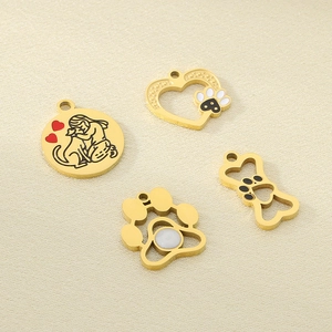 Detail of four 18k gold plated stainless steel animal heart and paw charm pendants