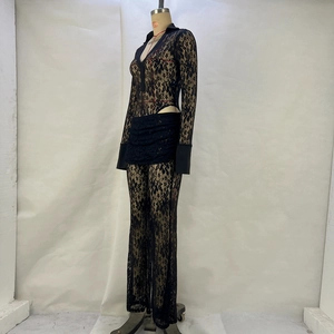 Close-up of black lace see-through set with deep V-neck and high-waist flared pants