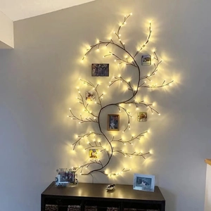 Solar powered branch lights with warm LED beads on wall with photos for Christmas decor
