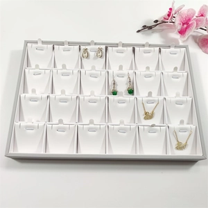 Detail of 24-slot jewelry display tray for necklaces and pendants in grey and white