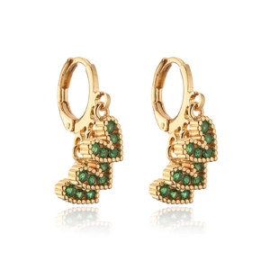 Macro detail of 18K gold plated earrings with three green heart-shaped zircon drops