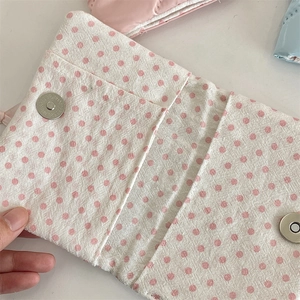 Detailed internal view of pink polka dot fabric travel passport holder with dual magnetic buckles