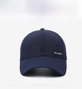 Detail view of navy blue baseball cap showing breathable laser-cut holes and RUIEE logo