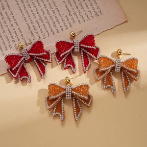 Elegant bow-shaped drop earrings with red and orange crystals and sparkling rhinestones