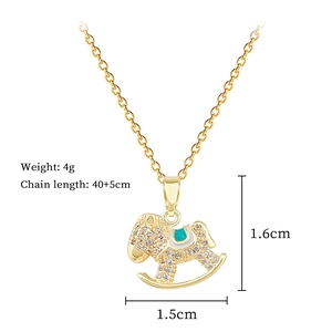 Close-up of a luxury gold rocking horse pendant necklace featuring sparkling rhinestones